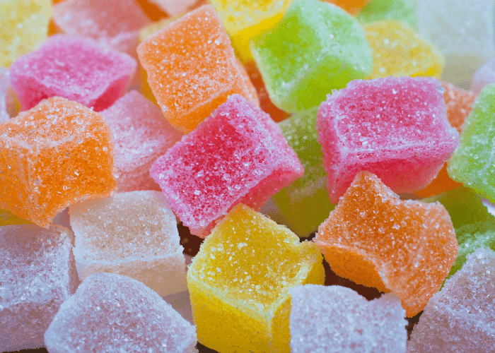 Cube-shaped THC gummies in different flavors and colors