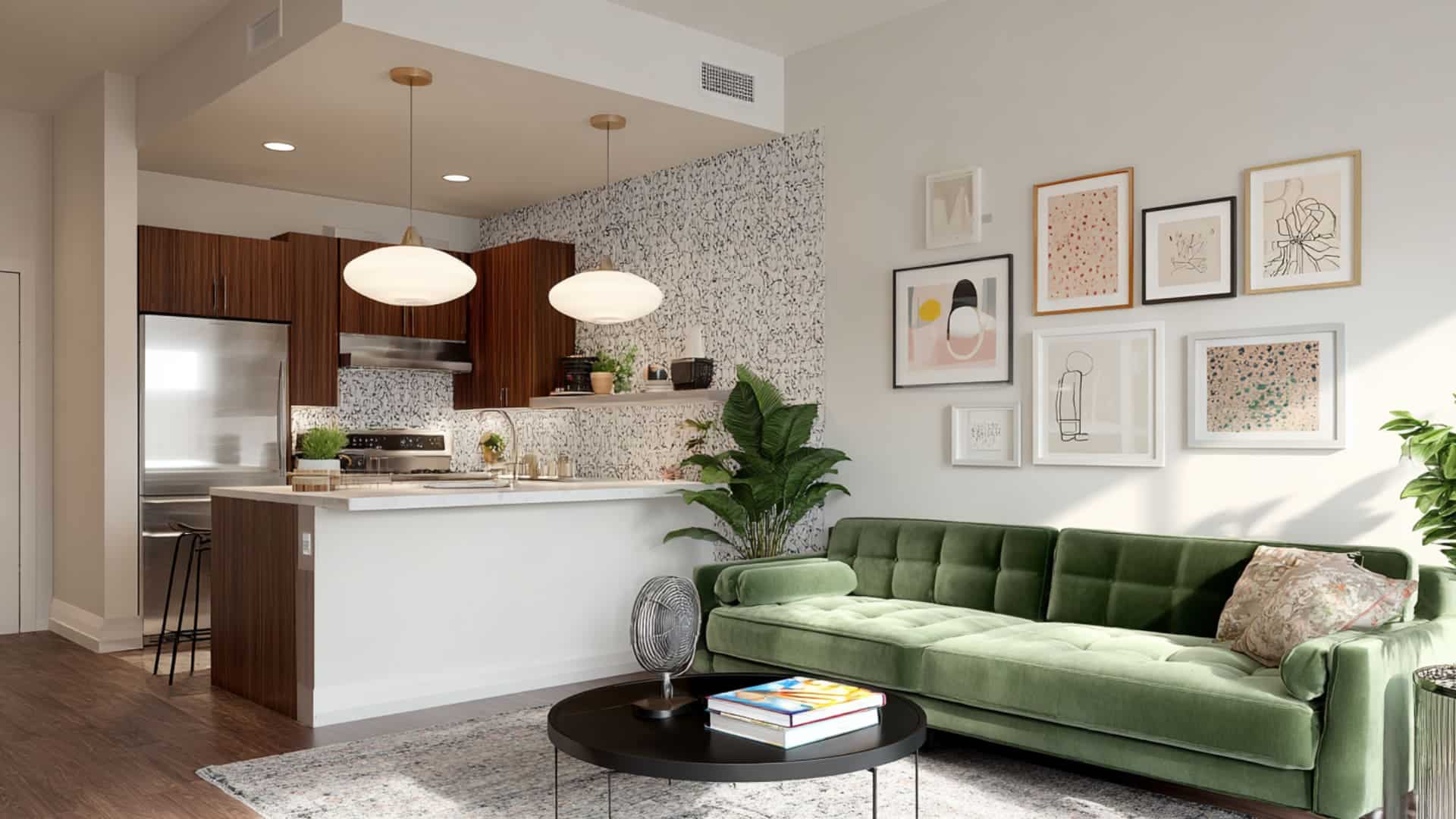 Small open-plan room with low-profile furniture, green sofa, breakfast bar, gallery wall, and patterned backsplash.