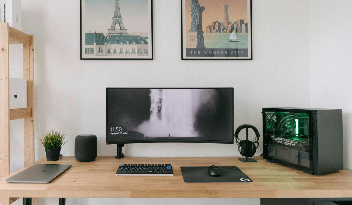 Ultrawide monitor and PC on a wooden desk