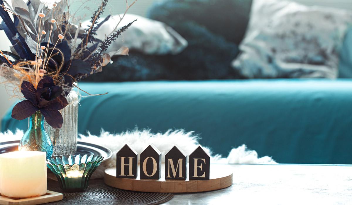 Cozy home decor with candle, flowers, and HOME sign