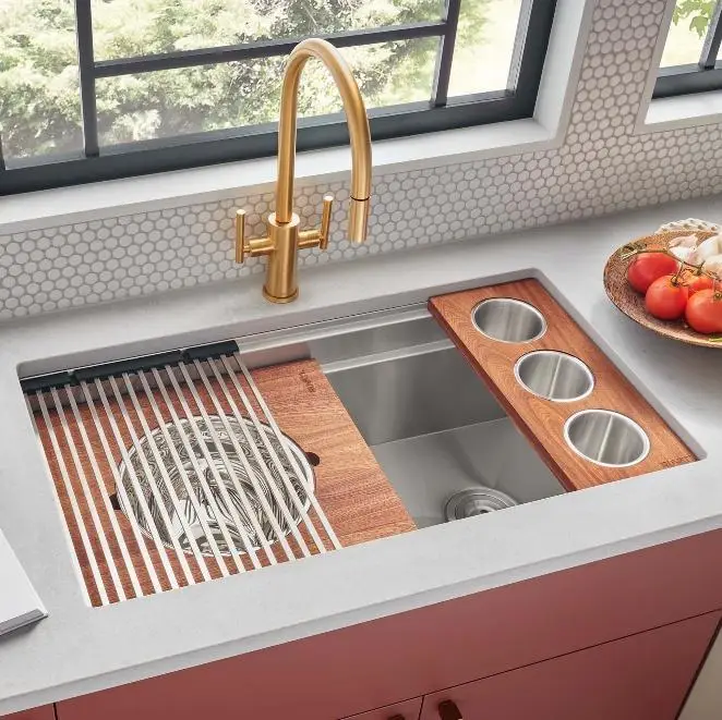 Modern kitchen sink with brass faucet and integrated wooden cutting boards