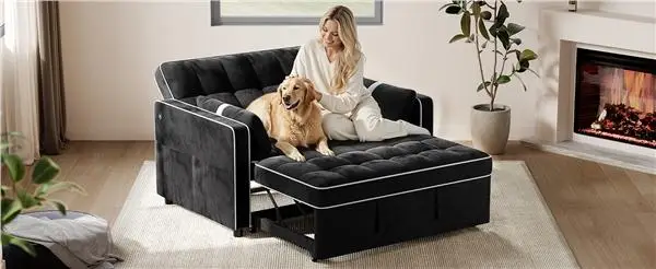 Woman sitting with golden retriever on black sofa bed in cozy living room with fireplace