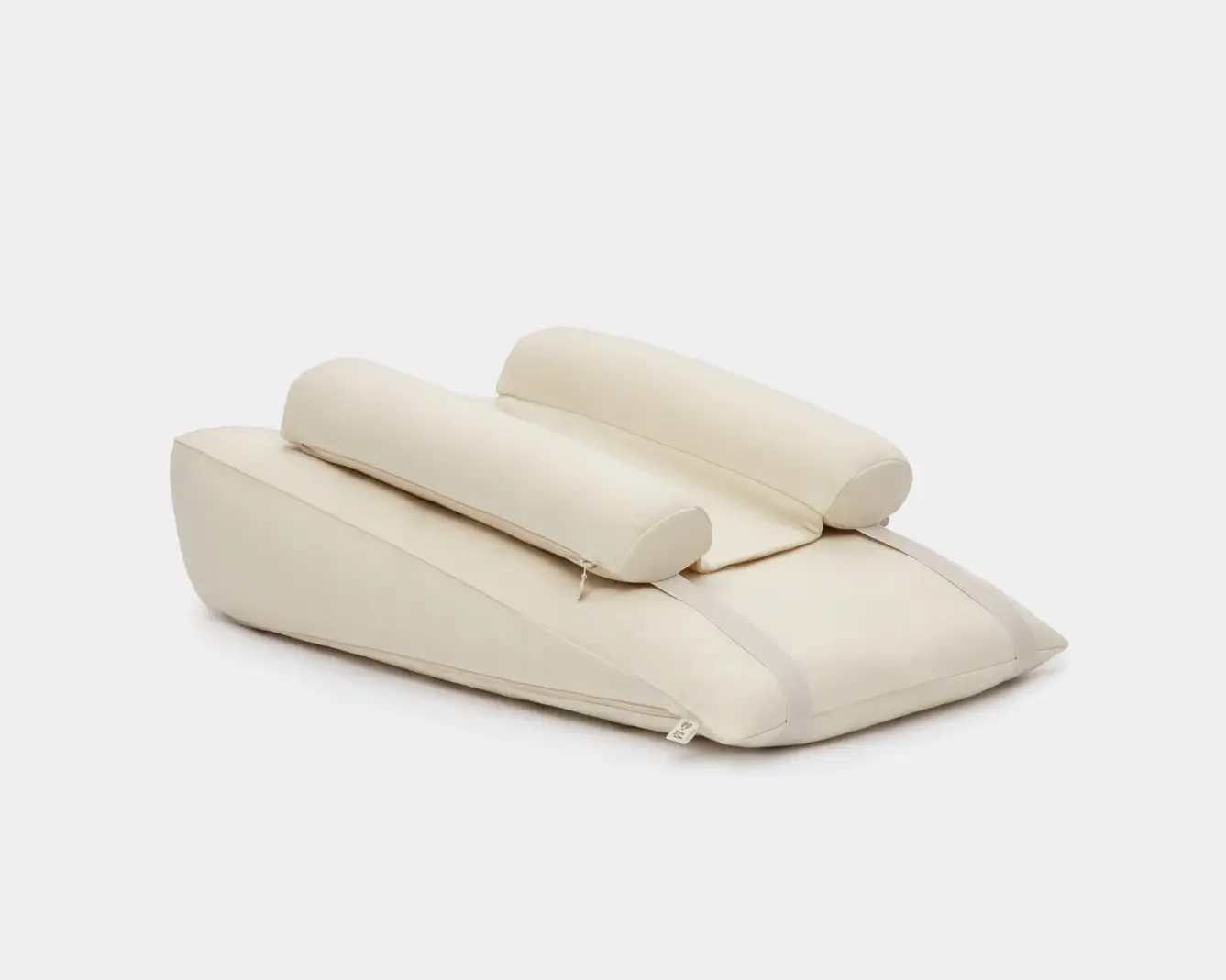 Cream-colored supportive cushion system with adjustable straps on white background
