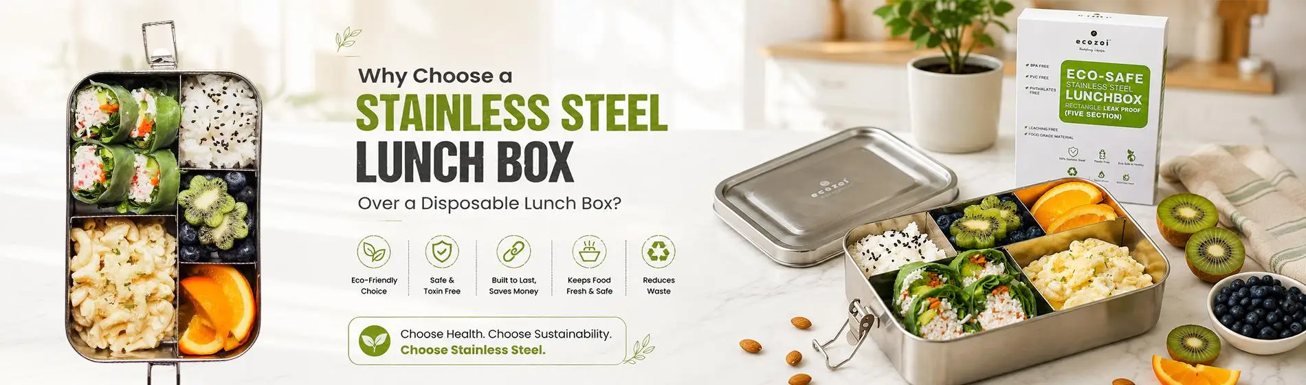 Stainless steel lunchbox with assorted foods on a marble countertop in a bright kitchen setting