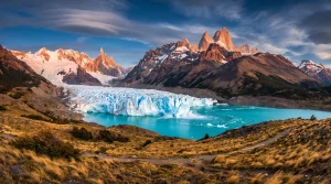 Majestic mountains and glacier with turquoise lake under dramatic sky in remote wilderness setting