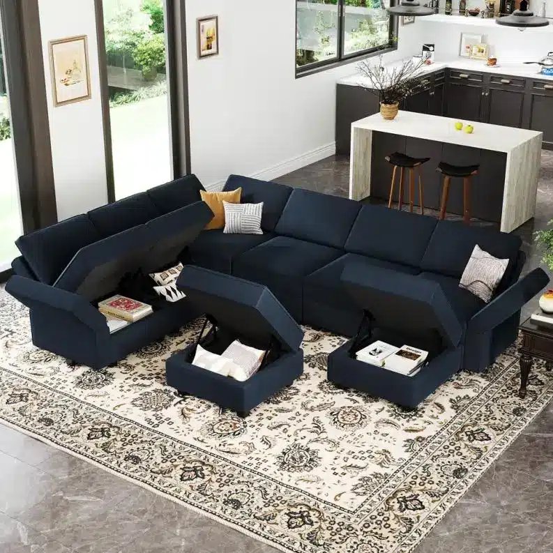 Dark blue sectional sofa with storage compartments in modern living room with large windows