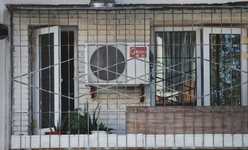 an air conditioner sitting on the side of a building