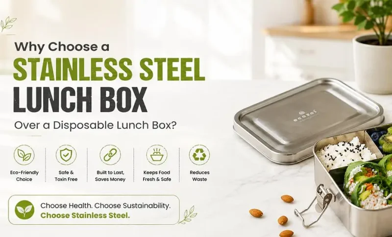 Stainless steel lunchbox with assorted foods on a marble countertop in a bright kitchen setting